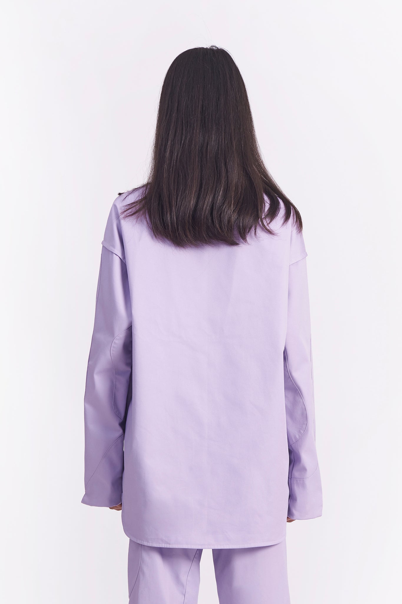  Each asymmetrical lavender patch is carefully hand-stitched into place and then sewn in. The patterns for this shirt are hand drawn, hand cut and finally assembled together by our studio tailor. 
